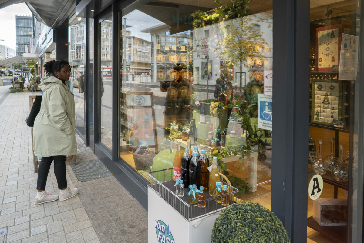 Teilnehmerin eines Zero waste Rundgangs der Klimacoaches in Bielefeld sieht sich die Auslage eines Unverpackt-Ladens an